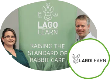 Two people standing in front of a Lago Learn banner