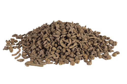A pile of dark brown, extruded rabbit food pellets with a rough, fibrous texture, shaped into small, irregular cylindrical pieces and heaped into a mound against a plain white background.